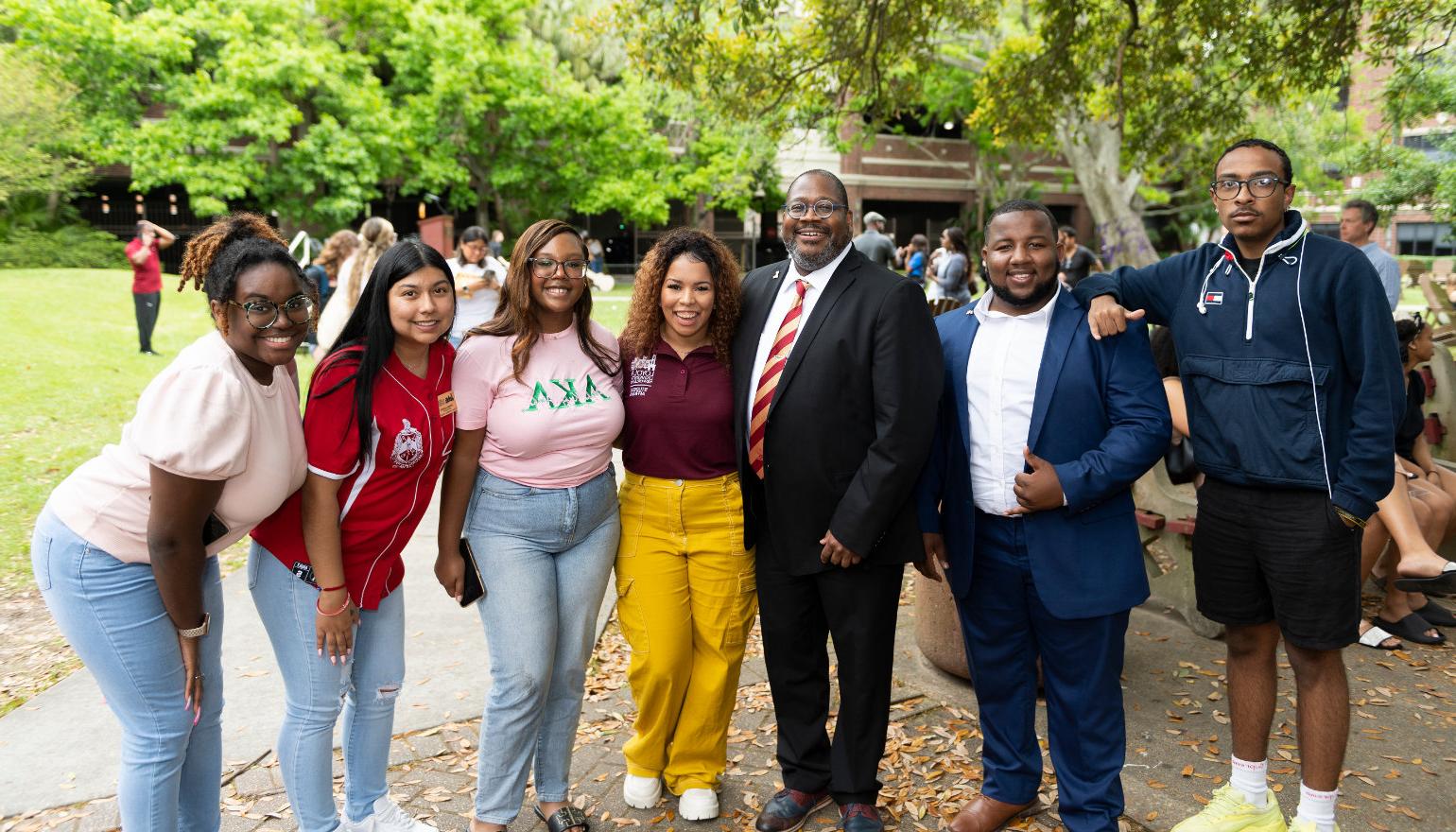 Dr. Cole poses with students and staff at the welcome event.